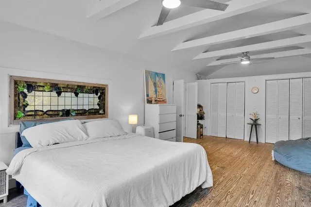 a bedroom with a large bed and a window