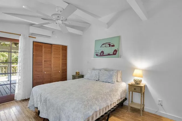 a bedroom with a large bed and a window