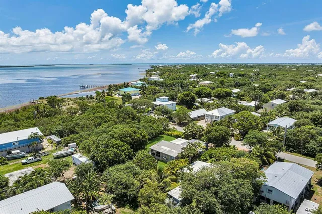 an aerial view of a houses with yard