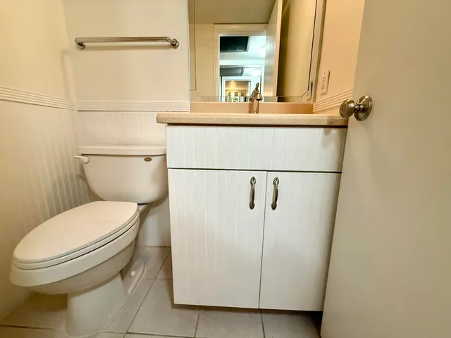 a white toilet sitting next to a bathroom sink
