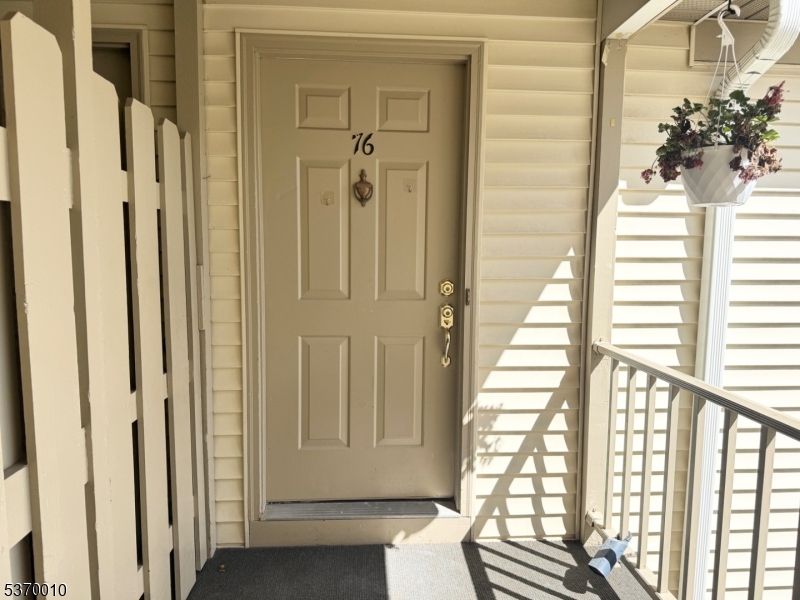 76 Jamestown Road Bernards, NJ 07920 - Photo 13 of 20 a view of a balcony with wooden floor and front door