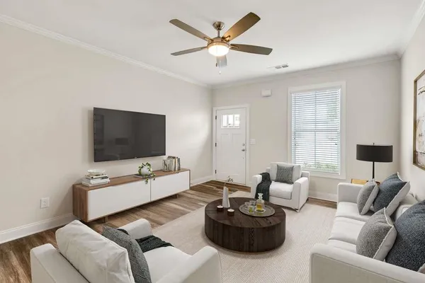 a living room with furniture a fireplace and a flat screen tv