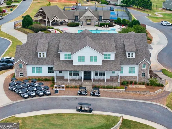 a view of a hallway with stairs and wooden floor