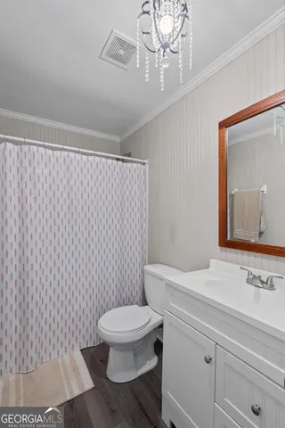 a bathroom with a toilet a sink and a mirror