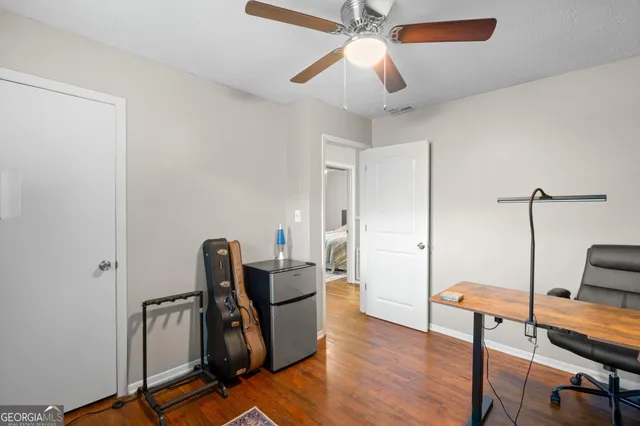 a view of a workspace with furniture and a window