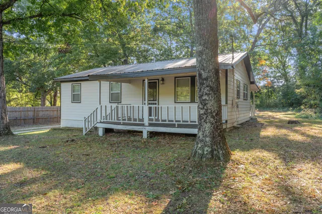 a backyard of a house with yard and outdoor seating