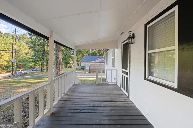 a view of a balcony with wooden floor and outdoor space
