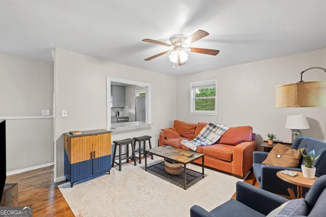 a living room with furniture a rug and a chandelier
