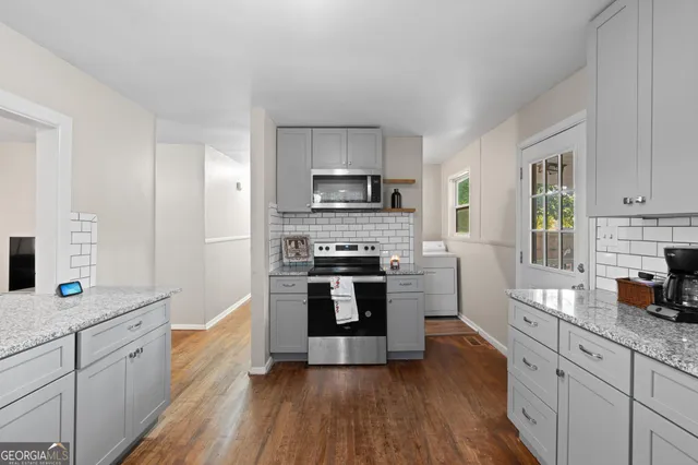 a kitchen with stainless steel appliances a stove sink and cabinets