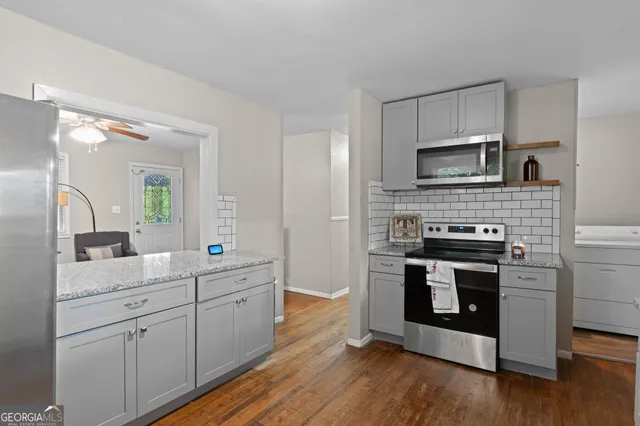 a kitchen with stainless steel appliances a stove sink and microwave