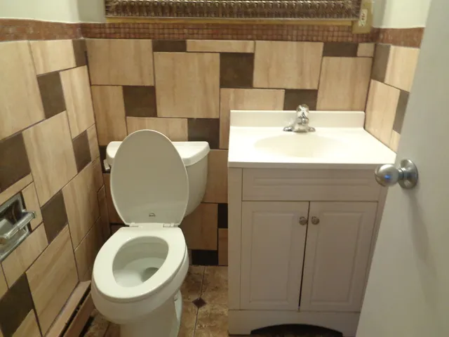 a bathroom with a sink mirror vanity and toilet