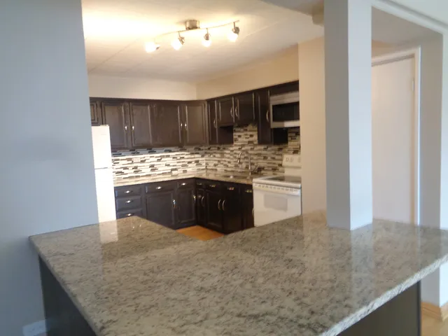 a kitchen with a stove and cabinets