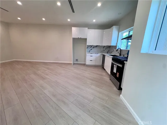 a view of kitchen with microwave and cabinets