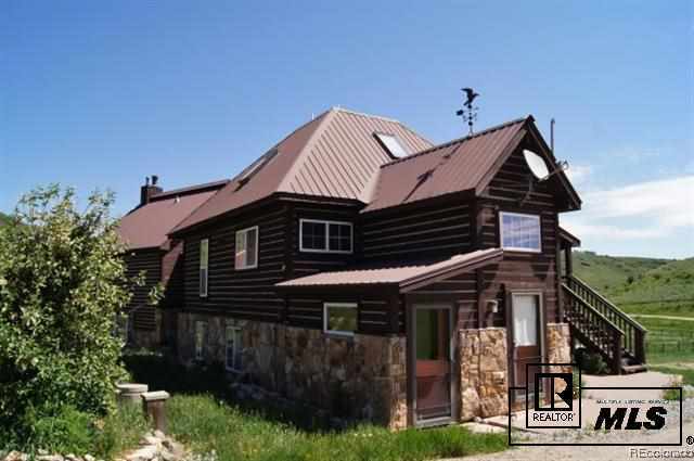 46450 Rcr 46 Steamboat Springs, Unit LONESOME EAGLE RANCH Steamboat Springs, CO 80487 - Photo 14 of 17 a front view of a house with garden
