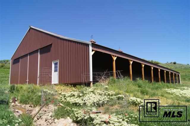 46450 Rcr 46 Steamboat Springs, Unit LONESOME EAGLE RANCH Steamboat Springs, CO 80487 - Photo 16 of 17 a backyard of a house with garden