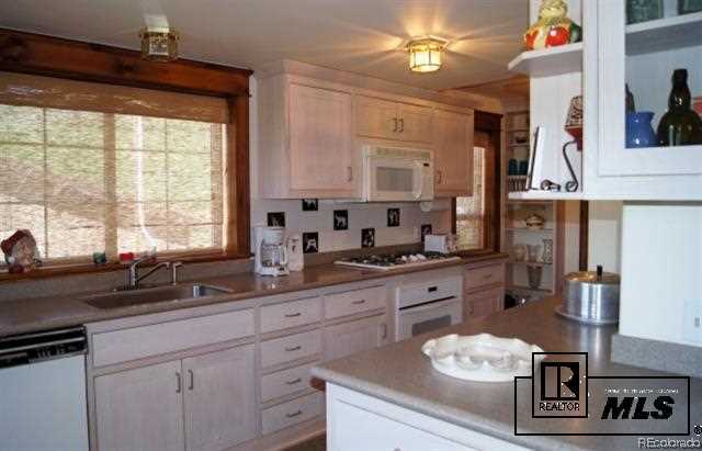 46450 Rcr 46 Steamboat Springs, Unit LONESOME EAGLE RANCH Steamboat Springs, CO 80487 - Photo 7 of 17 a kitchen with stainless steel appliances a sink stove and window