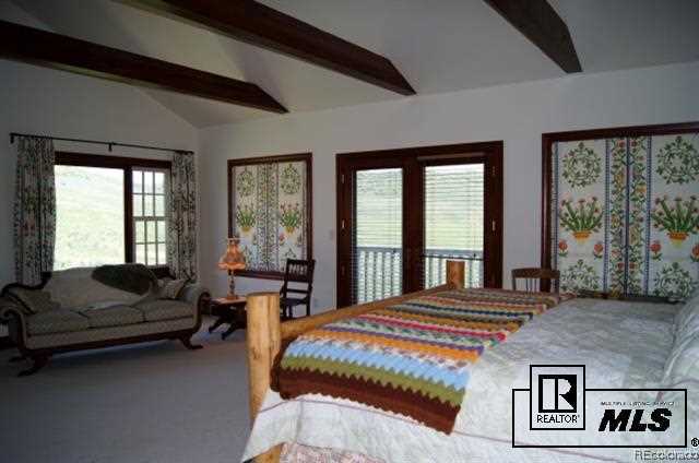 46450 Rcr 46 Steamboat Springs, Unit LONESOME EAGLE RANCH Steamboat Springs, CO 80487 - Photo 10 of 17 a bedroom with a large bed couch and two large window