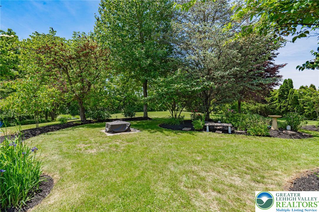 4542 Springfield Drive Coplay, PA 18037 - Photo 67 of 89 A verdant backyard retreat offering privacy and natural beauty, perfect for outdoor enjoyment.