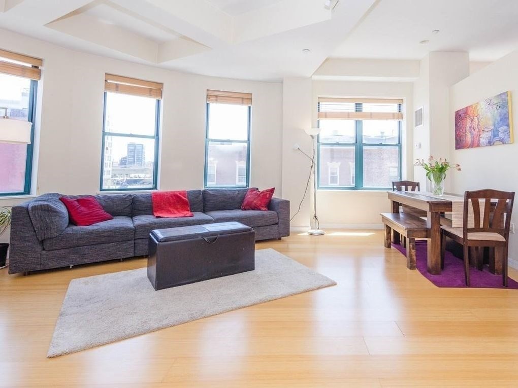 a living room with furniture window and wooden floor