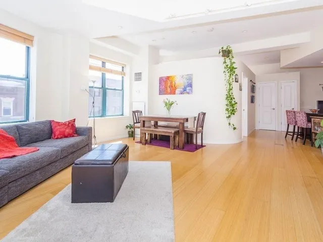 a living room with furniture and large windows