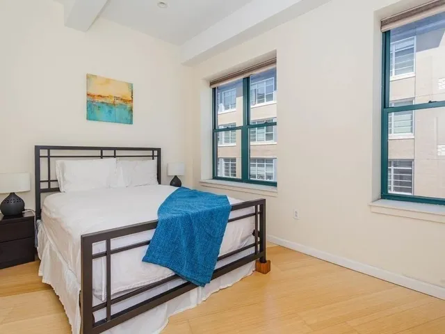 a bedroom with a bed and window