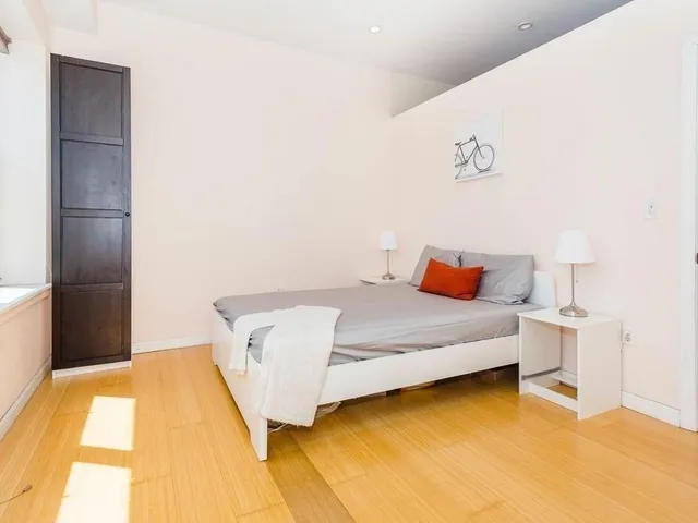 a bedroom with a bed and a table