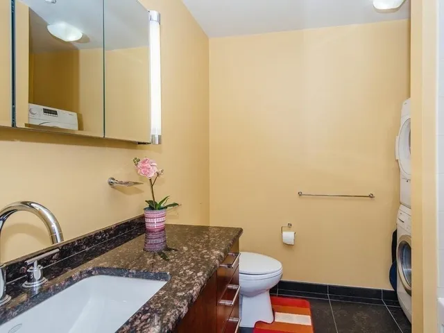 a bathroom with a sink a toilet and mirror