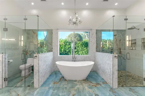 a large room with a chandelier and fireplace