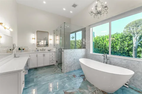 a white bath tub sitting in a bathroom with a large tub