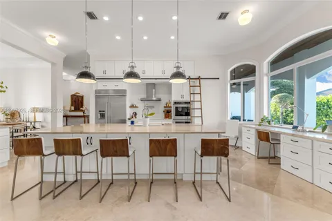 a large kitchen with lots of counter space and stainless steel appliances