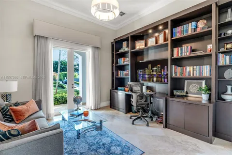 a living room with furniture and a book shelf