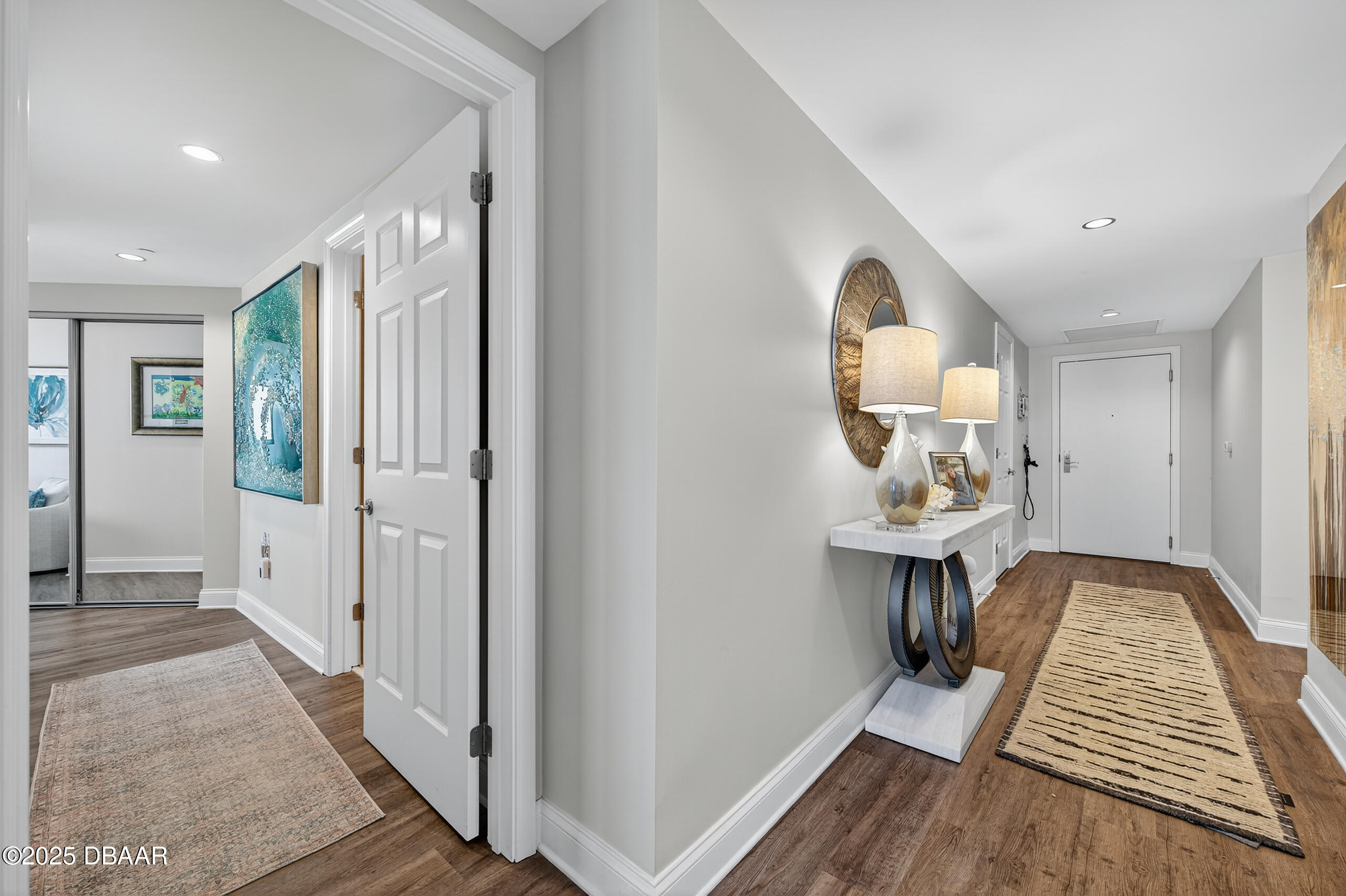 231 Riverside Drive, Unit 1602 Holly Hill, FL 32117 - Photo 20 of 45 a view of room with wooden floor mirror and a sink