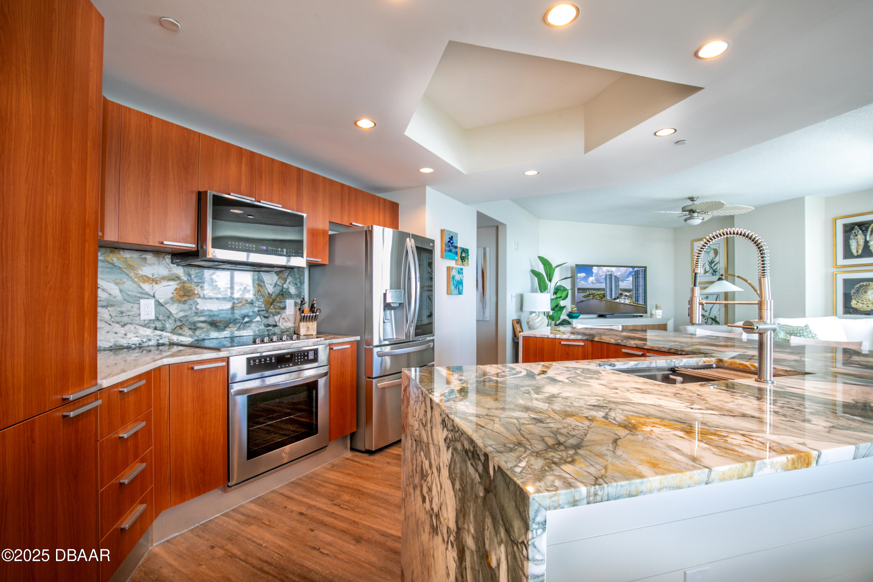 231 Riverside Drive, Unit 1602 Holly Hill, FL 32117 - Photo 3 of 45 a kitchen with stainless steel appliances granite countertop sink stove and refrigerator