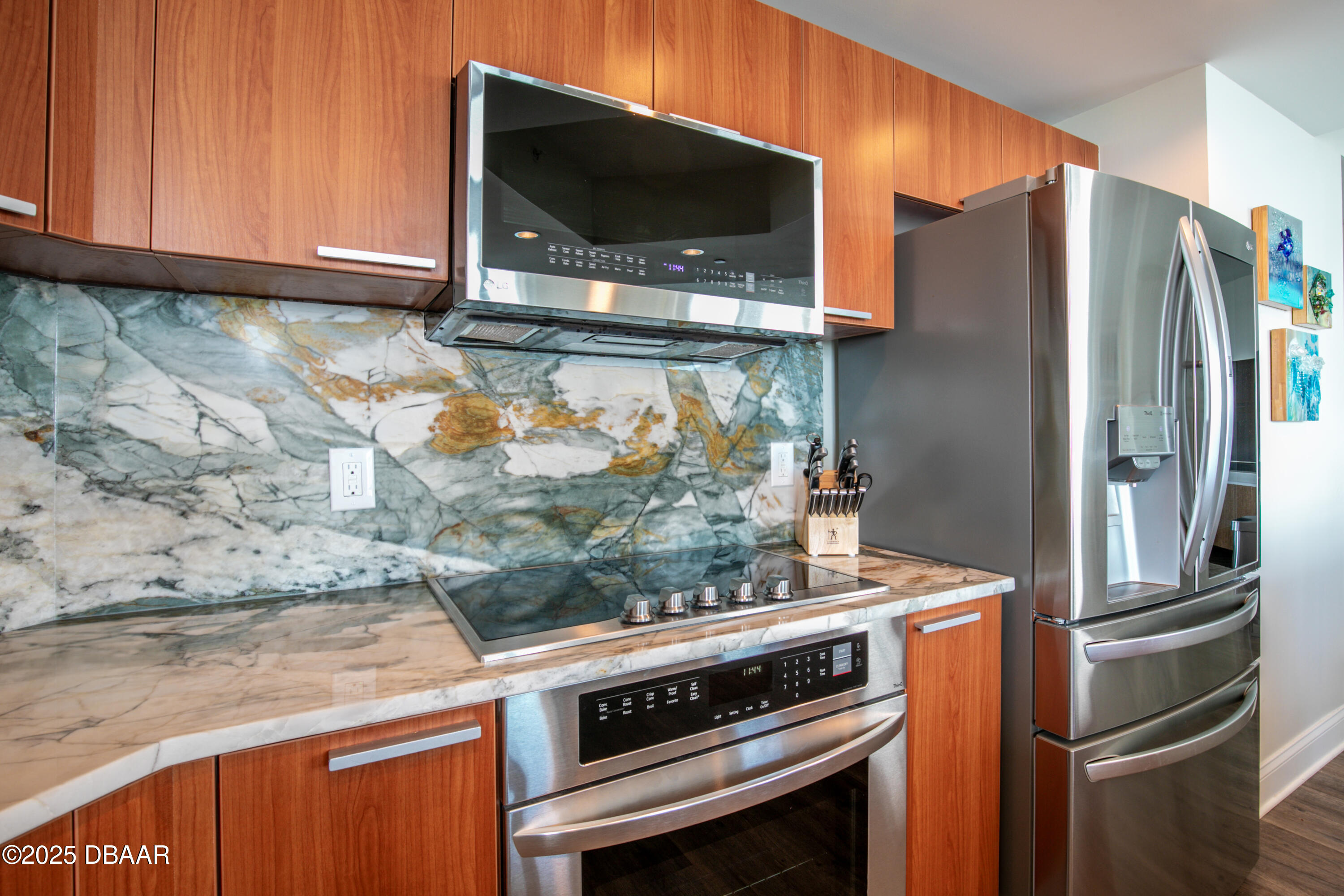 231 Riverside Drive, Unit 1602 Holly Hill, FL 32117 - Photo 8 of 45 a kitchen with stainless steel appliances granite countertop a stove microwave and refrigerator