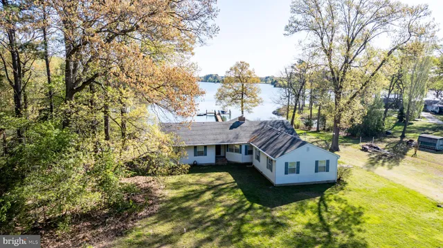 a view of a house with pool and sitting area