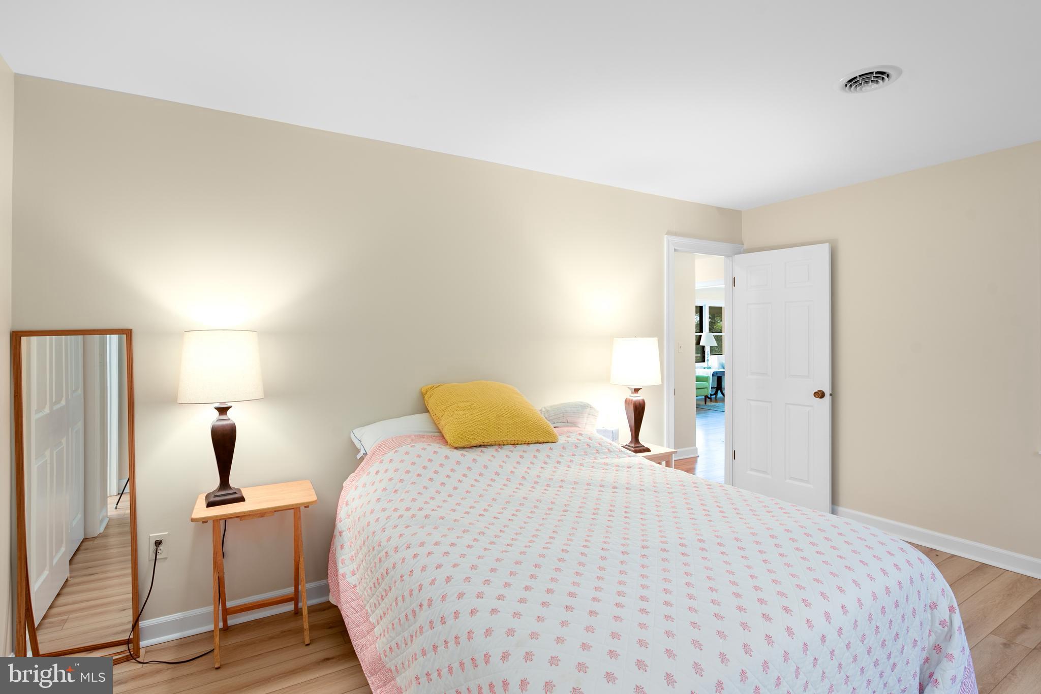 6379 Cedar Cove Road Royal Oak, MD 21662 - Photo 15 of 32 a bedroom with a bed and wooden floor