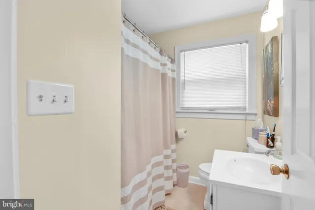 a bathroom with a sink a bath tub and a window