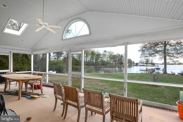 a view of a porch with chairs and backyard