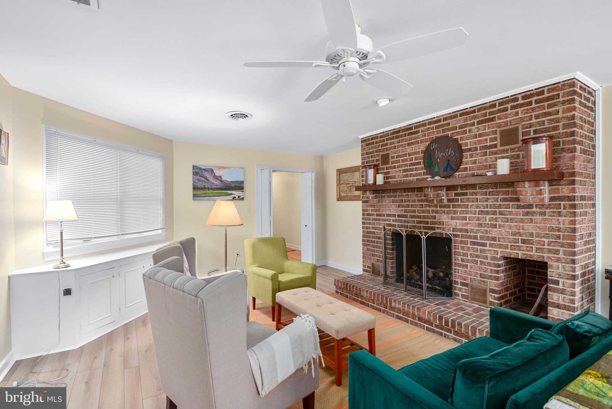 6379 Cedar Cove Road Royal Oak, MD 21662 - Photo 6 of 32 a living room with furniture and a fireplace