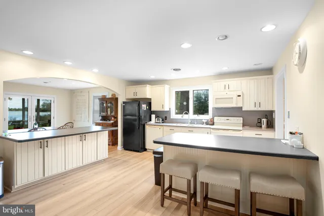 a large kitchen with a table and chairs