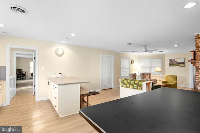 a living room with kitchen island furniture and a wooden floor