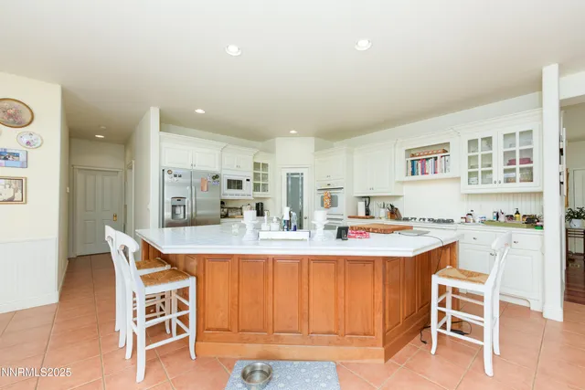 a large kitchen with a table and chairs in it