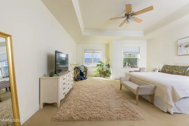 a bed room with a bed a television and a couch