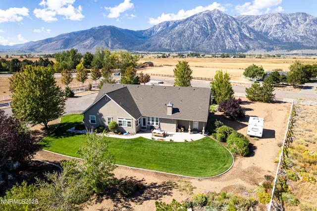 a aerial view of a house with a yard and lake view