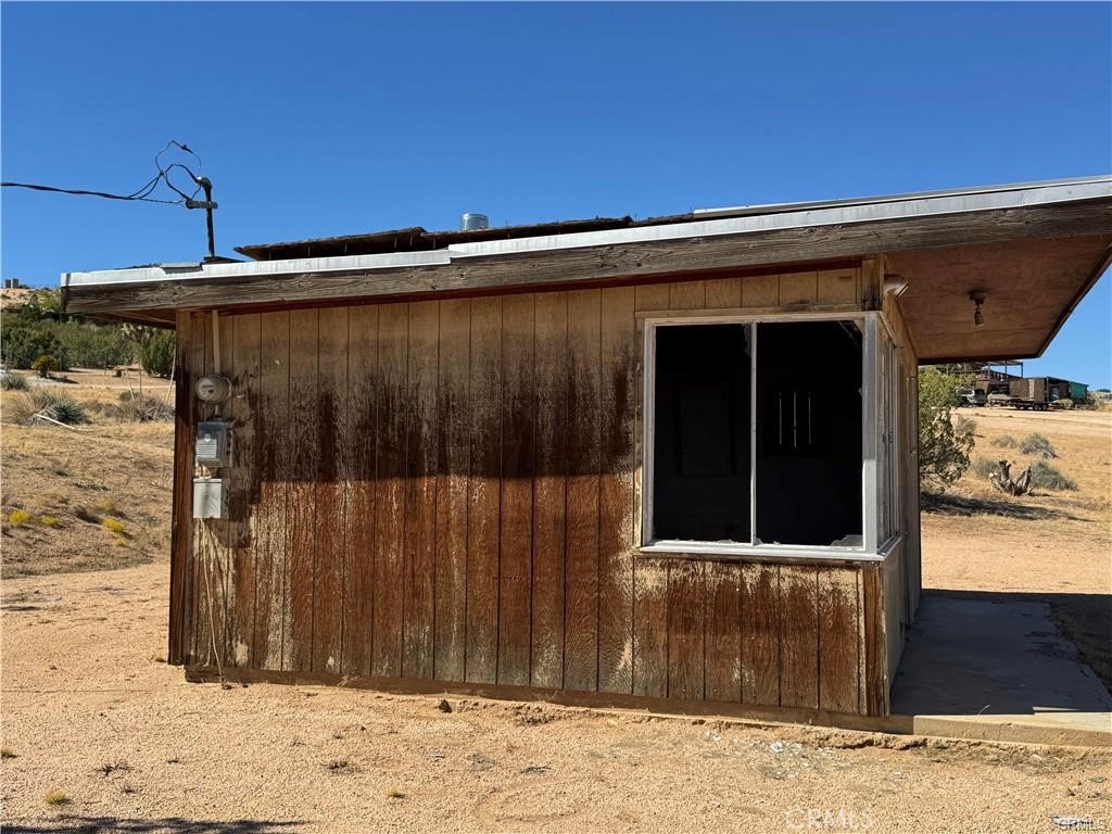 23766 Valley View Road Apple Valley, CA 92308 - Photo 5 of 16 a black car parked in front of a building