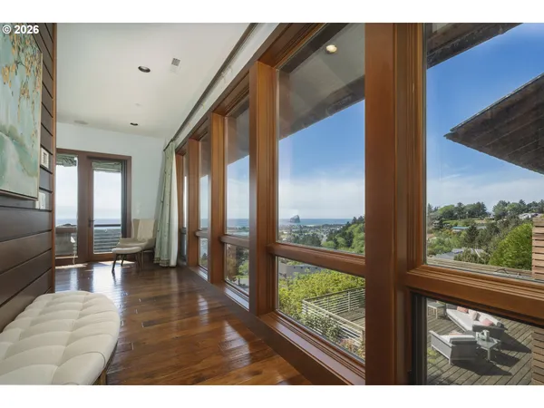 a living room with a large window and a floor to ceiling window