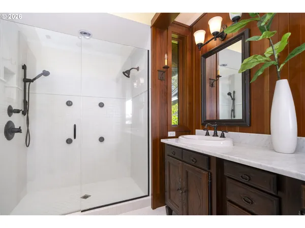 a kitchen with stainless steel appliances kitchen island granite countertop a table chairs and a refrigerator