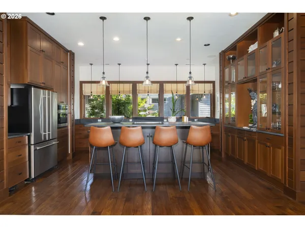 a kitchen with a table chairs sink and cabinets