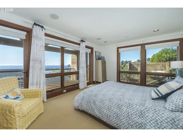 a bedroom with a large bed and a large window