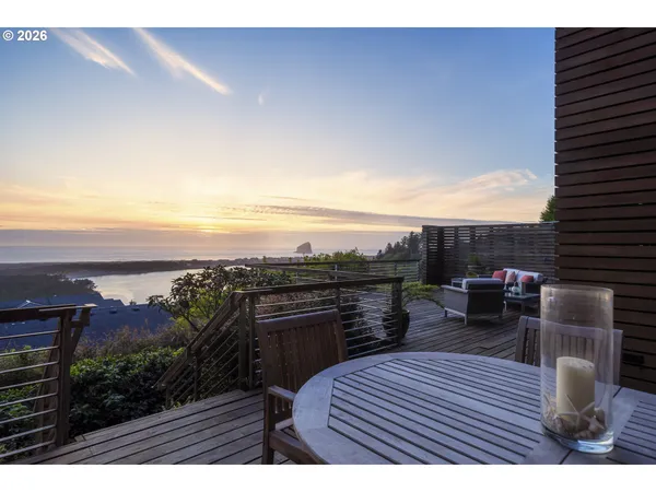a view of roof deck with seating space and trees in the background